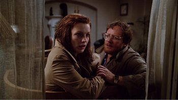 Movie still from “Altered States” (1980), directed by Ken Russell – A man and a woman sitting next to each other in a room; Medium shot, Low angle