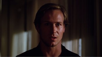 Movie still from “Altered States” (1980), directed by Ken Russell – A person wearing a black t - shirt; Close Up shot, Over the shoulder angle