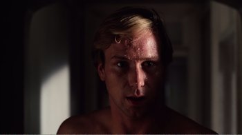 Movie still from “Altered States” (1980), directed by Ken Russell – A person's face in the dark; Close Up shot, Low angle