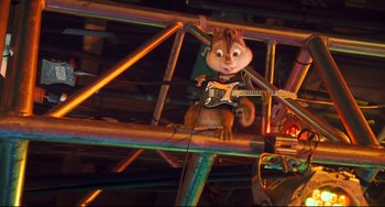 Movie still from “Alvin and the Chipmunks: The Squeakquel” (2009), directed by Betty Thomas – A chipmunk holding a guitar while sitting on a metal structure; Medium shot, Low angle