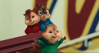 Movie still from “Alvin and the Chipmunks: The Squeakquel” (2009), directed by Betty Thomas – A group of chipmunks sitting next to each other on a bench; Medium shot, Low angle