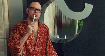 Movie still from “Alvin and the Chipmunks: The Squeakquel” (2009), directed by Betty Thomas – A bald man in a red robe brushing his teeth; Close Up shot, Over the shoulder angle