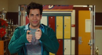 Movie still from “Alvin and the Chipmunks: The Squeakquel” (2009), directed by Betty Thomas – A young man pointing at the camera in front of lockers; Medium shot, Over the shoulder angle