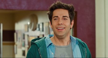 Movie still from “Alvin and the Chipmunks: The Squeakquel” (2009), directed by Betty Thomas – A person smiling for the camera; Close Up shot, Over the shoulder angle