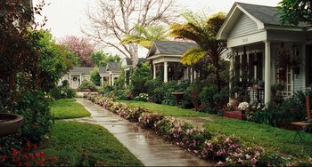 Movie still from “Alvin and the Chipmunks: The Squeakquel” (2009), directed by Betty Thomas – A row of houses with flowers growing on the side of the road; Extreme Wide shot, High angle