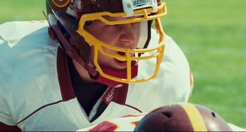 A person wearing a football helmet