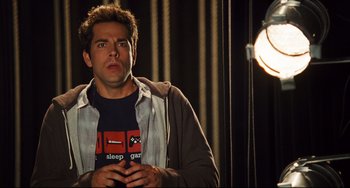 Movie still from “Alvin and the Chipmunks: The Squeakquel” (2009), directed by Betty Thomas – A man standing in front of a light; Medium shot, Overhead angle