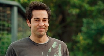 Movie still from “Alvin and the Chipmunks: The Squeakquel” (2009), directed by Betty Thomas – A person wearing a t - shirt; Close Up shot, Over the shoulder angle