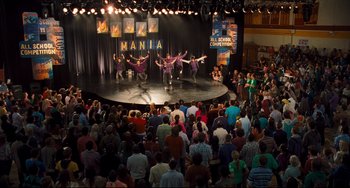 Movie still from “Alvin and the Chipmunks: The Squeakquel” (2009), directed by Betty Thomas – A group of people on a stage performing a dance; Extreme Wide shot, High angle