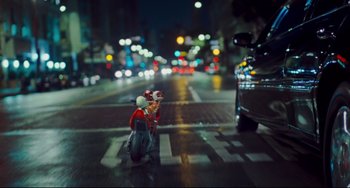 Movie still from “Alvin and the Chipmunks: The Squeakquel” (2009), directed by Betty Thomas – A person riding a scooter on a street at night; Extreme Wide shot, High angle