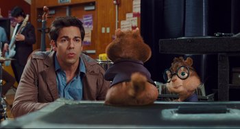 Movie still from “Alvin and the Chipmunks: The Squeakquel” (2009), directed by Betty Thomas – A couple of people sitting next to a stuffed animal; Medium shot, Over the shoulder angle