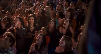 Movie still from “Alvin and the Chipmunks: The Squeakquel” (2009), directed by Betty Thomas – A group of people sitting in a room clapping; Wide shot, High angle