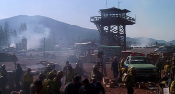 Movie still from “Always” (1989), directed by Steven Spielberg – A group of people standing next to each other on top of a hill; Extreme Wide shot, High angle