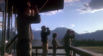 Movie still from “Always” (1989), directed by Steven Spielberg – A group of people standing on top of a wooden deck; Wide shot, Low angle