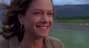 Movie still from “Always” (1989), directed by Steven Spielberg – A person smiling; Close Up shot, Low angle