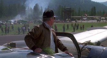 Movie still from “Always” (1989), directed by Steven Spielberg – An older man standing next to an airplane; Wide shot, Over the shoulder angle