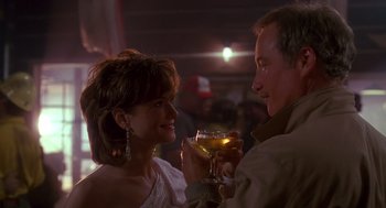 Movie still from “Always” (1989), directed by Steven Spielberg – A man and a woman are holding wine glasses; Close Up shot, Over the shoulder angle