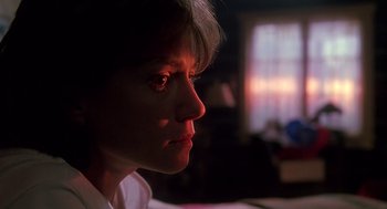 Movie still from “Always” (1989), directed by Steven Spielberg – A woman with short white hair looking to her left; Close Up shot, Low angle