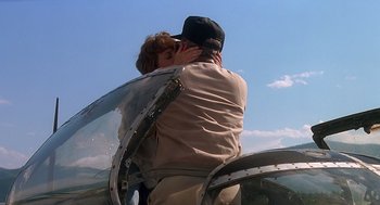 Movie still from “Always” (1989), directed by Steven Spielberg – A man and a woman kissing on top of an airplane wing; Medium shot, Low angle