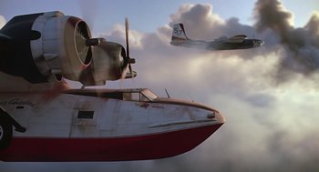 Movie still from “Always” (1989), directed by Steven Spielberg – Two planes flying in the air with a cloudy sky behind them; Wide shot, Low angle