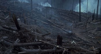 Movie still from “Always” (1989), directed by Steven Spielberg – A forest that has been cut down and has smoke coming out of it; Extreme Wide shot, High angle