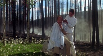 Movie still from “Always” (1989), directed by Steven Spielberg – A man getting his hair cut by another man; Medium shot, Low angle