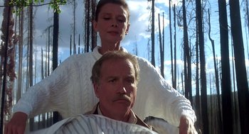 Movie still from “Always” (1989), directed by Steven Spielberg – A man getting his hair combed by a woman; Medium shot, Low angle