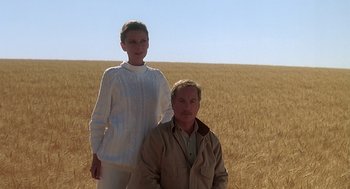 Movie still from “Always” (1989), directed by Steven Spielberg – A man and a woman standing in the middle of a wheat field; Wide shot, Low angle