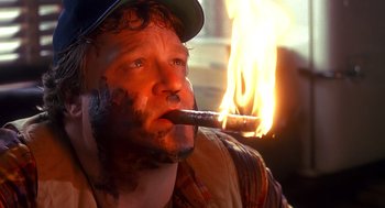 Movie still from “Always” (1989), directed by Steven Spielberg – A person smoking a cigar; Close Up shot, Low angle