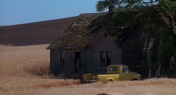 Movie still from “Always” (1989), directed by Steven Spielberg – An old truck parked in front of an abandoned house; Extreme Wide shot, High angle