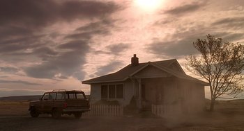Movie still from “Always” (1989), directed by Steven Spielberg – A truck parked in front of a house on a cloudy day; Extreme Wide shot, Low angle