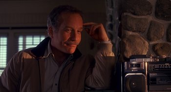 Movie still from “Always” (1989), directed by Steven Spielberg – A man with a mustache is leaning against a wall; Close Up shot, Low angle