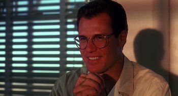 Movie still from “Always” (1989), directed by Steven Spielberg – A person wearing glasses and smiling; Close Up shot, Low angle