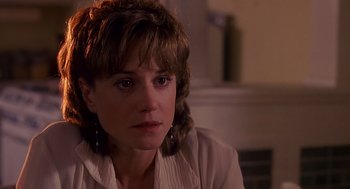 Movie still from “Always” (1989), directed by Steven Spielberg – A person sitting in front of a window; Close Up shot, Over the shoulder angle