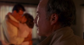 Movie still from “Always” (1989), directed by Steven Spielberg – An older man looks off into the distance; Close Up shot, Over the shoulder angle