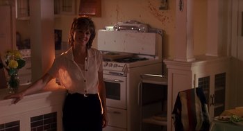 Movie still from “Always” (1989), directed by Steven Spielberg – A woman standing in front of an oven in a kitchen; Medium shot, Low angle