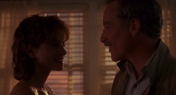 Movie still from “Always” (1989), directed by Steven Spielberg – A man and a woman smiling at each other; Close Up shot, Low angle