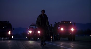 Movie still from “Always” (1989), directed by Steven Spielberg – A group of people walking down a street at night; Wide shot, Low angle