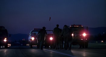 Movie still from “Always” (1989), directed by Steven Spielberg – A group of people standing on the side of a road; Extreme Wide shot, Low angle