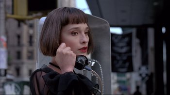 A woman with short brown hair talking on a phone
