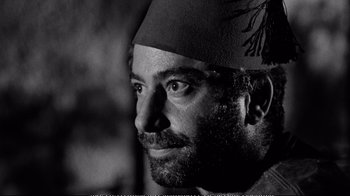 Movie still from “America America” (1963), directed by Elia Kazan – Black and white photograph of a man wearing a hat; Close Up shot, Low angle