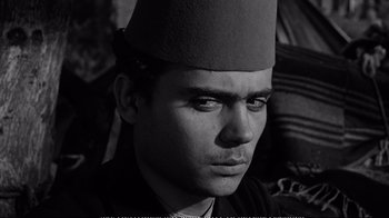 Movie still from “America America” (1963), directed by Elia Kazan – A black and white photo of a man wearing a fez; Close Up shot, High angle