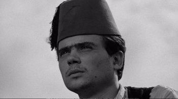 Movie still from “America America” (1963), directed by Elia Kazan – A black and white photo of a man wearing a fez; Close Up shot, Low angle