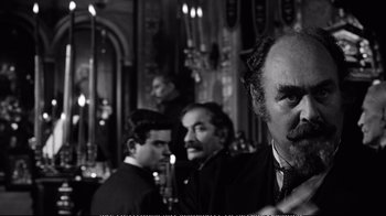 Movie still from “America America” (1963), directed by Elia Kazan – A black and white photo of a group of people; Close Up shot, Over the shoulder angle