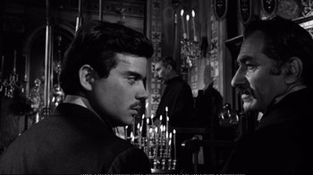 Movie still from “America America” (1963), directed by Elia Kazan – A man sitting in front of a group of candles; Close Up shot, Over the shoulder angle