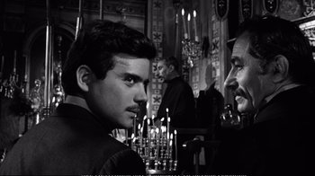 Movie still from “America America” (1963), directed by Elia Kazan – Two men in front of candles in a room; Close Up shot, Over the shoulder angle