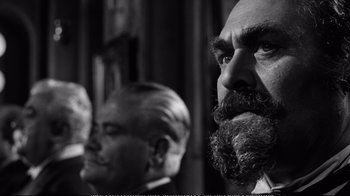 Movie still from “America America” (1963), directed by Elia Kazan – A man with a beard and a goatee is looking at the camera; Close Up shot, Low angle