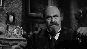 Movie still from “America America” (1963), directed by Elia Kazan – An old man with a beard and a mustache; Close Up shot, Over the shoulder angle