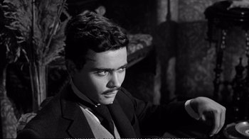 Movie still from “America America” (1963), directed by Elia Kazan – A black and white photo of a man in a suit and tie; Close Up shot, High angle