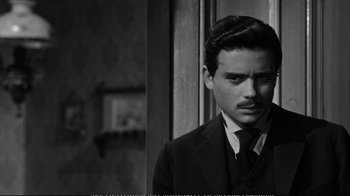 Movie still from “America America” (1963), directed by Elia Kazan – A black and white photo of a man in a suit and tie; Close Up shot, Over the shoulder angle